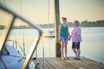 Living liver donor transplant - daughter Sarah and mother Kathy holding hands on dock